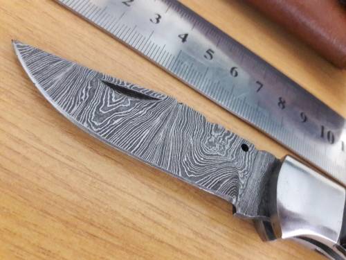 Handmade Damascus steel folding knife with BULL HORN handle scales.