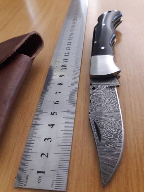 Handmade Damascus steel folding knife with BULL HORN handle scales.