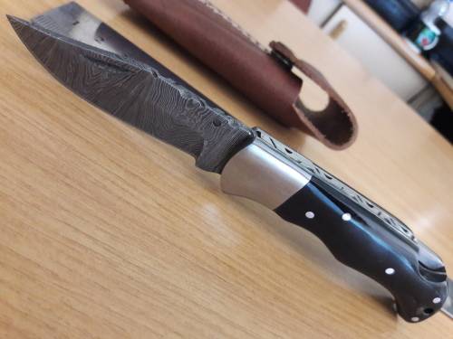 Handmade Damascus steel folding knife with BULL HORN handle scales.