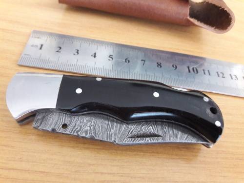 Handmade Damascus steel folding knife with BULL HORN handle scales.