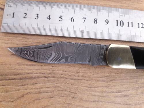 Handmade Damascus steel folding knife with Bull Horn handle scales.