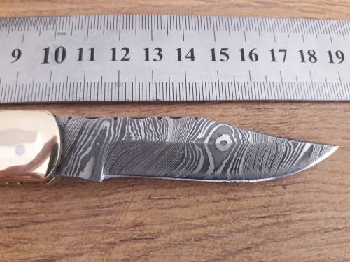 Handmade Damascus steel folding knife with Bull Horn handle scales.