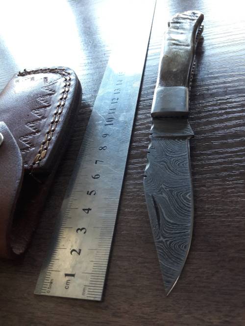 Handmade Damascus steel folding knife with RAM HORN handle scales.