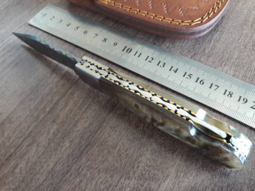 Handmade Damascus steel folding knife with RAM HORN handle scales.
