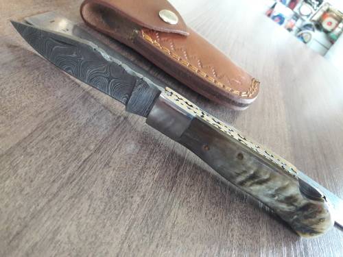 Handmade Damascus steel folding knife with RAM HORN handle scales.