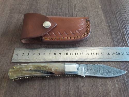 Handmade Damascus steel folding knife with RAM HORN handle scales.