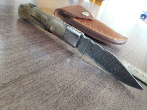 Handmade Damascus steel folding knife with RAM HORN handle scales.
