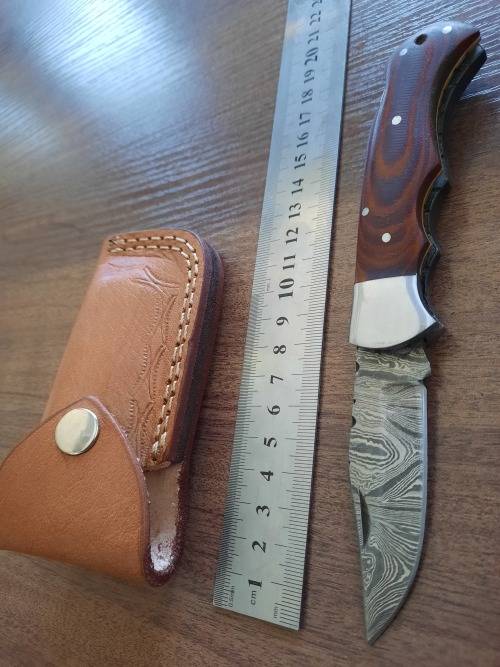 Handmade Damascus steel folding knife with MICARTA handle scales.