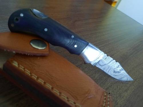 Handmade Damascus steel folding knife with MICARTA handle scales.