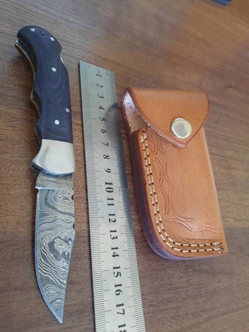 Handmade Damascus steel folding knife with MICARTA handle scales.