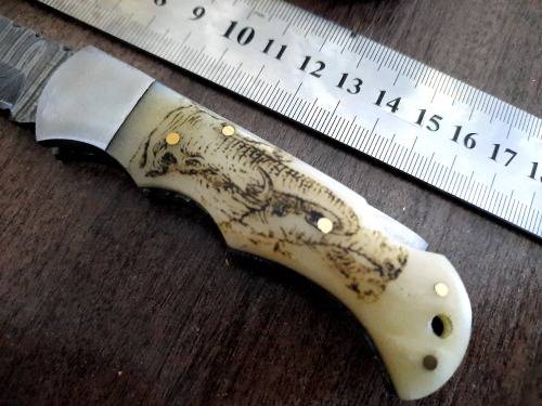 Handmade Damascus steel folding knife w Camel Bone Handle Scales. Art engraved.