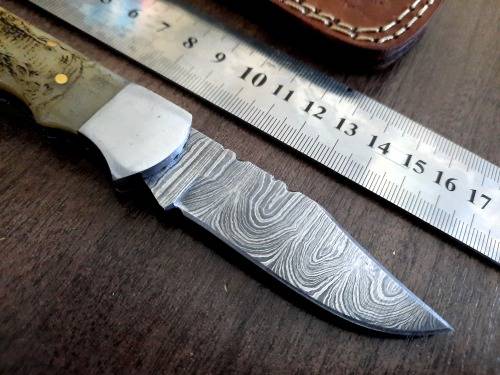 Handmade Damascus steel folding knife w Camel Bone Handle Scales. Art engraved.