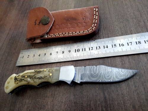 Handmade Damascus steel folding knife w Camel Bone Handle Scales. Art engraved.