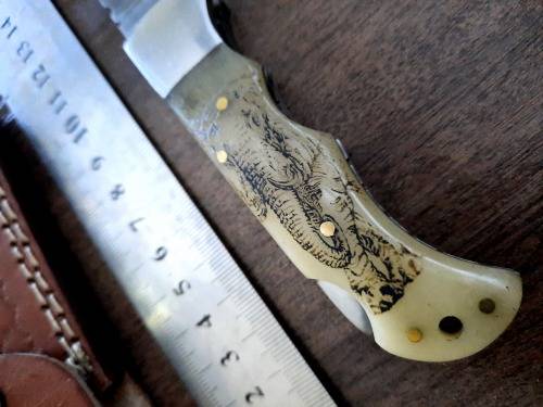 Handmade Damascus steel folding knife w Camel Bone Handle Scales. Art engraved.