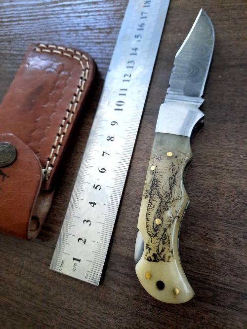 Handmade Damascus steel folding knife w Camel Bone Handle Scales. Art engraved.