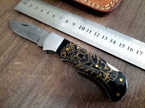 Handmade Damascus steel folding knife with Bull Horn Handle. Tiger picture engraved.