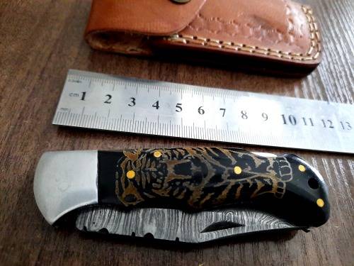Handmade Damascus steel folding knife with Bull Horn Handle. Tiger picture engraved.