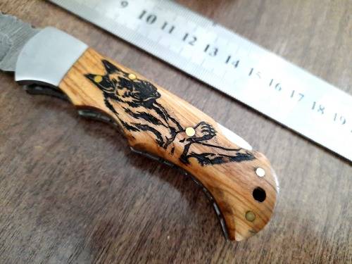 Handmade Damascus steel folding knife with wooden handle scales. Picture engraved. NEW STOCK !