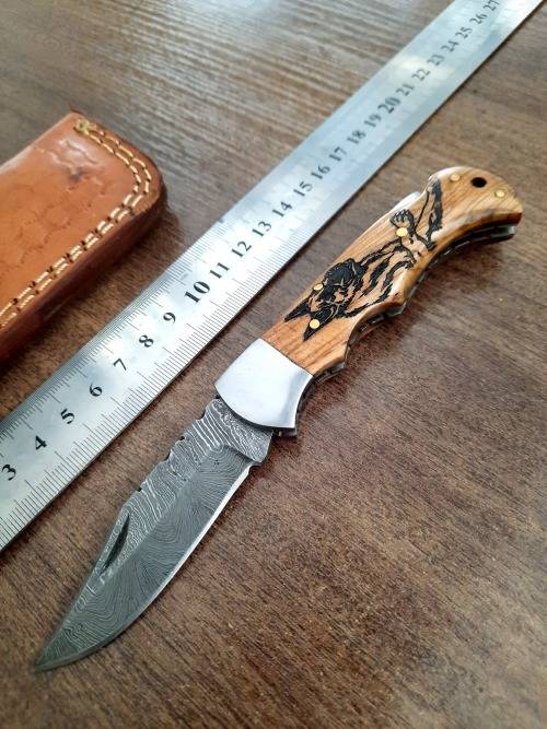 Handmade Damascus steel folding knife with wooden handle scales. Picture engraved. NEW STOCK !