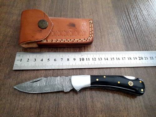 Handmade Damascus steel folding knife with Epoxy Resin handle scales. Leather pouch included.