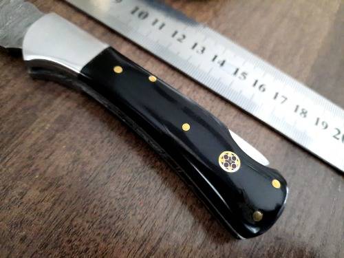 Handmade Damascus steel folding knife with Epoxy Resin handle scales. Leather pouch included.