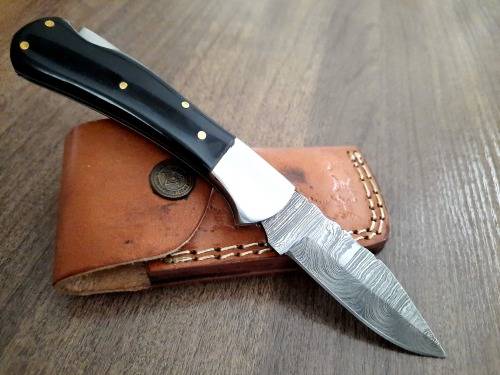 Handmade Damascus steel folding knife with Epoxy Resin handle scales. Leather pouch included.