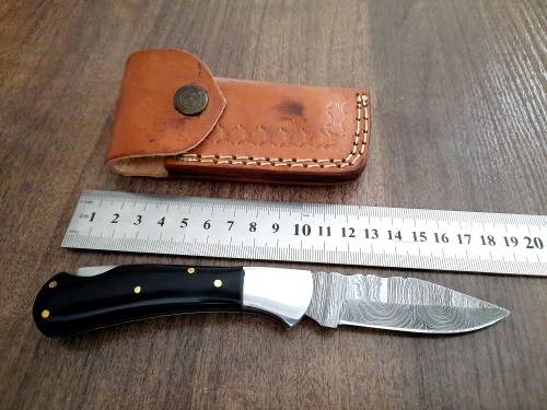 Handmade Damascus steel folding knife with Epoxy Resin handle scales. Leather pouch included.