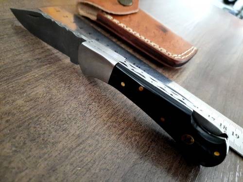 Handmade Damascus steel folding knife with Epoxy Resin handle scales. Leather pouch included.