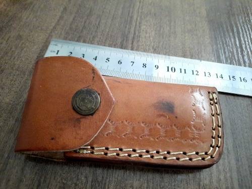 Handmade Damascus steel folding knife with Epoxy Resin handle scales. Leather pouch included.