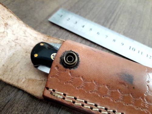 Handmade Damascus steel folding knife with Epoxy Resin handle scales. Leather pouch included.