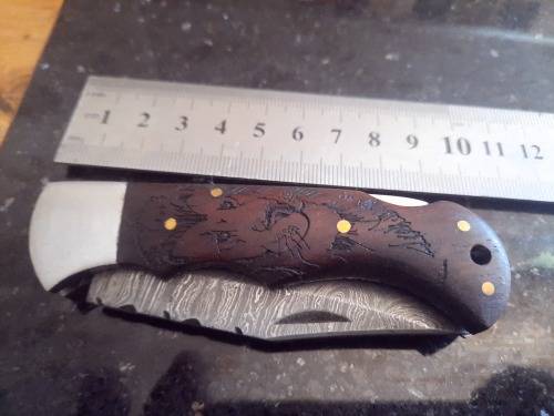 Handmade Damascus steel folding knife w Wooden Handle Scales. Pouch in bad shape, see pictures.