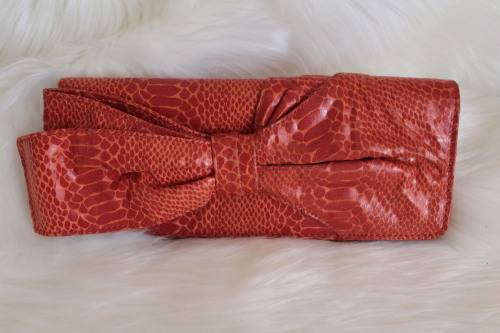 Orange Nine West Clutch with Faux Snakeskin and Bow Detail (Measures 12 x 26 cm)