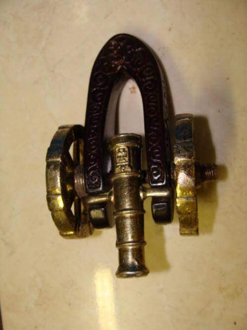 SMALL ORNAMENTAL METAL CANNON WITH WOODEN BACK AND WHEELS & CANNON IN METAL