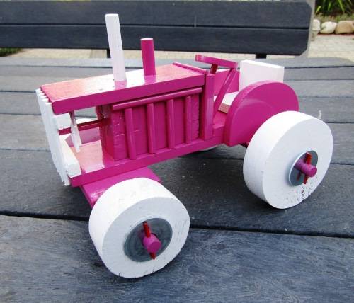 HAND MADE LARGE WOODEN FARM TRACTOR IN HOT PINK. VERY STURDY. NOT A DINKY TOY.