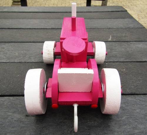 HAND MADE LARGE WOODEN FARM TRACTOR IN HOT PINK. VERY STURDY. NOT A DINKY TOY.