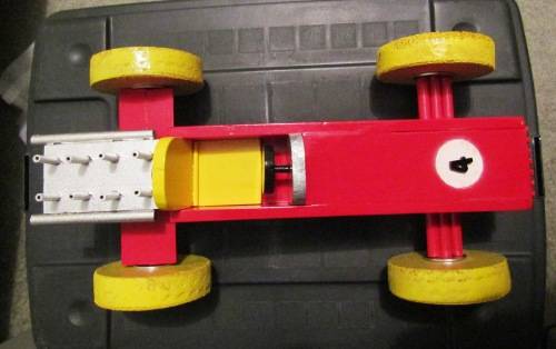 LARGE HAND MADE WOODEN `F1 RACING CAR` IN RED WITH YELLOW WHEELS. TOUGH STRUCTURE. NOT DINKY.