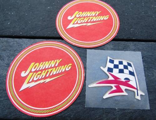 TWO JOHNNY LIGHTNING COASTERS AND A VINTAGE UNUSED `SASOL` STICKER.