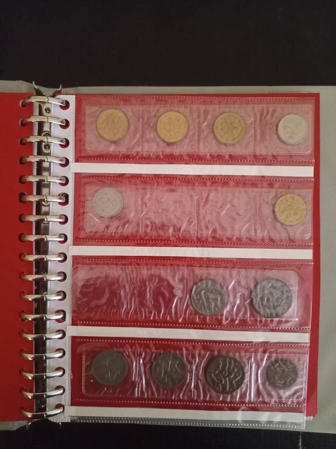 14 Page album filled with over 100 World  coins