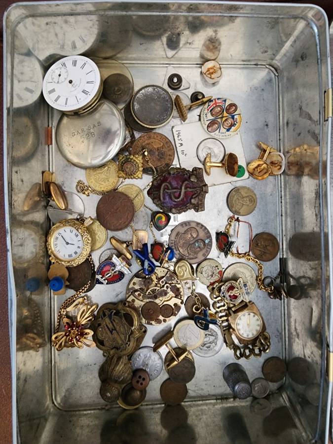 Old tin box full of watches  pocket watches, coins and pins