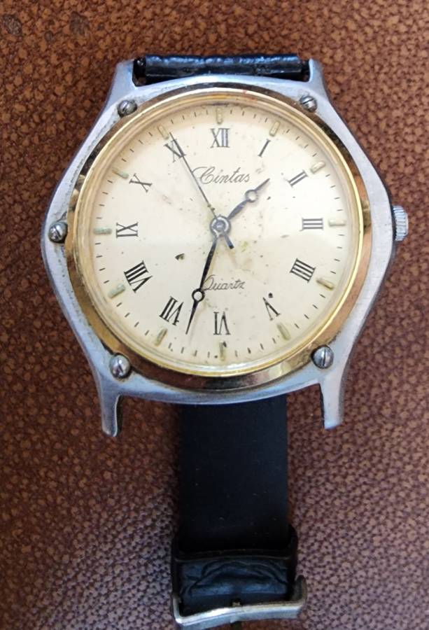 Old tin box full of watches  pocket watches, coins and pins