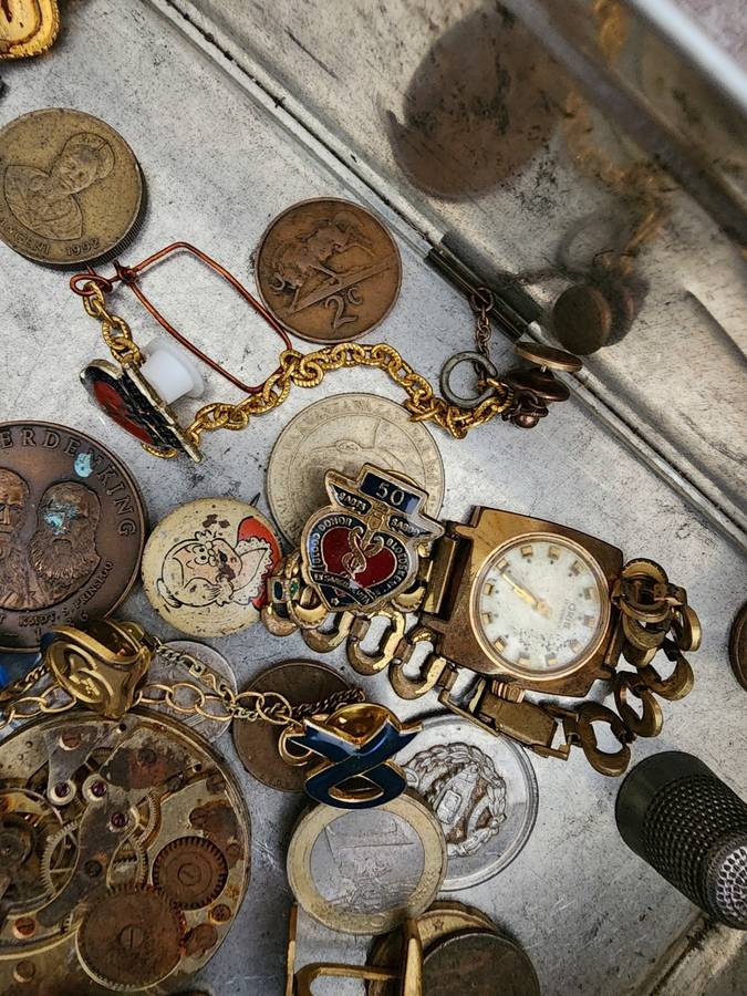 Old tin box full of watches  pocket watches, coins and pins
