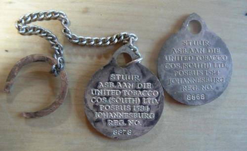 Pair of rare United Tobacco Johannesburg key tokens, numbered - one with chain and horseshoe