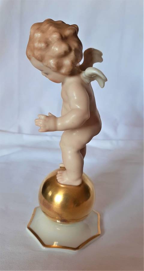 Superb Quality Hutschenreuther Gorgeous fat winged cherub standing on a gold ball, Signed Tutter.