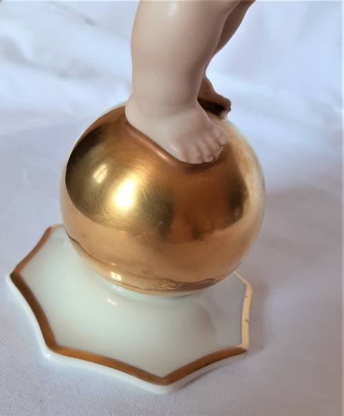 Superb Quality Hutschenreuther Gorgeous fat winged cherub standing on a gold ball, Signed Tutter.
