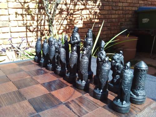 MEDIEVAL FIGURINE`S ON AN AMAZING HAND CRAFTED MARANTI WOOD CHESS BOARD