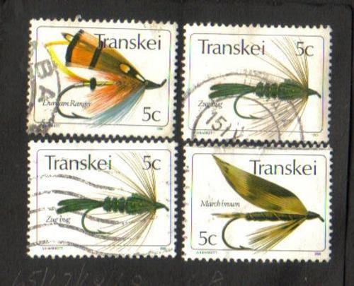 Transkei. 4 Used stamps hinged on paper