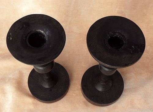 A PAIR OF HAND CARVED WOODEN CANDLE HOLDERS