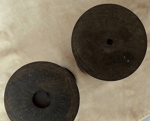 A PAIR OF HAND CARVED WOODEN CANDLE HOLDERS