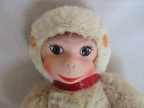 A VINTAGE 1950's/60's FULLY JOINTED MOHAIR RUBBER-FACED SCHUCO MONKEY WITH FELT EARS AND SQUEAKER