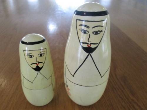 AN UNUSUAL FOUR PIECE HAND PAINTED MATRYOSHKA/BABUSHKA NESTING DOLL SET